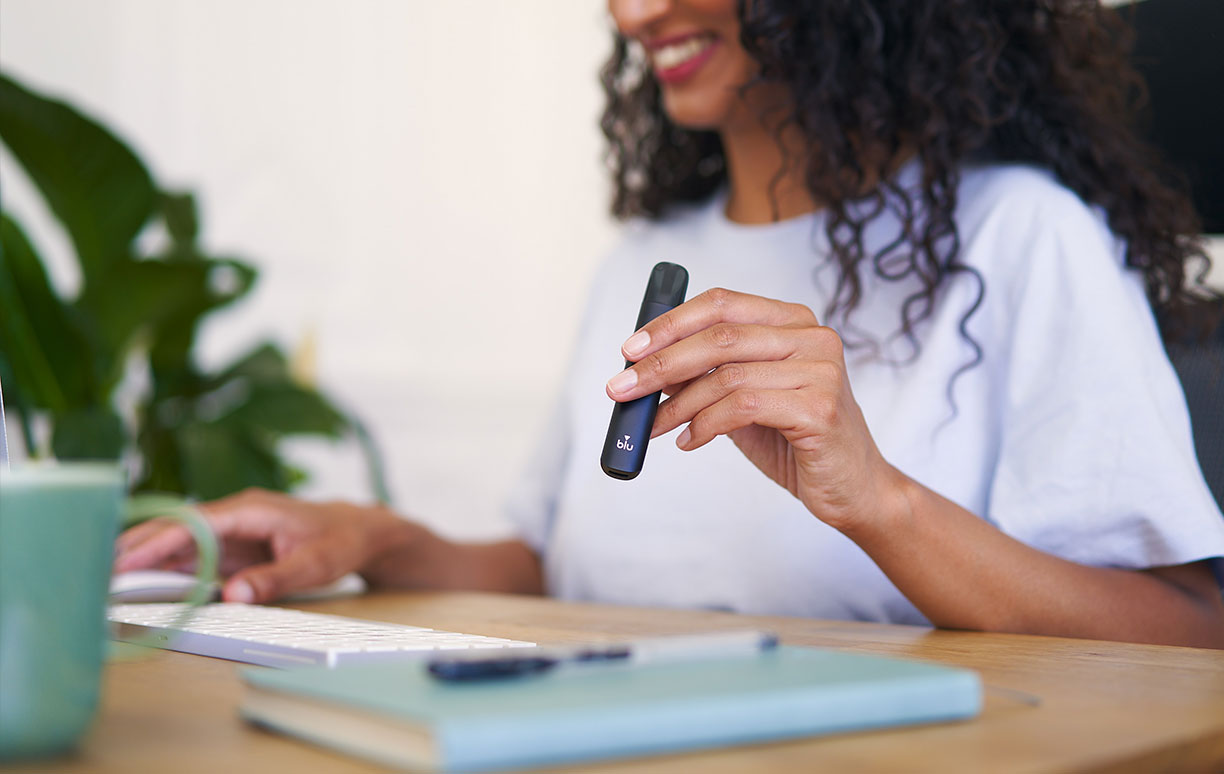 Woman Vaping at Workstation Woman Vaping at Workstation